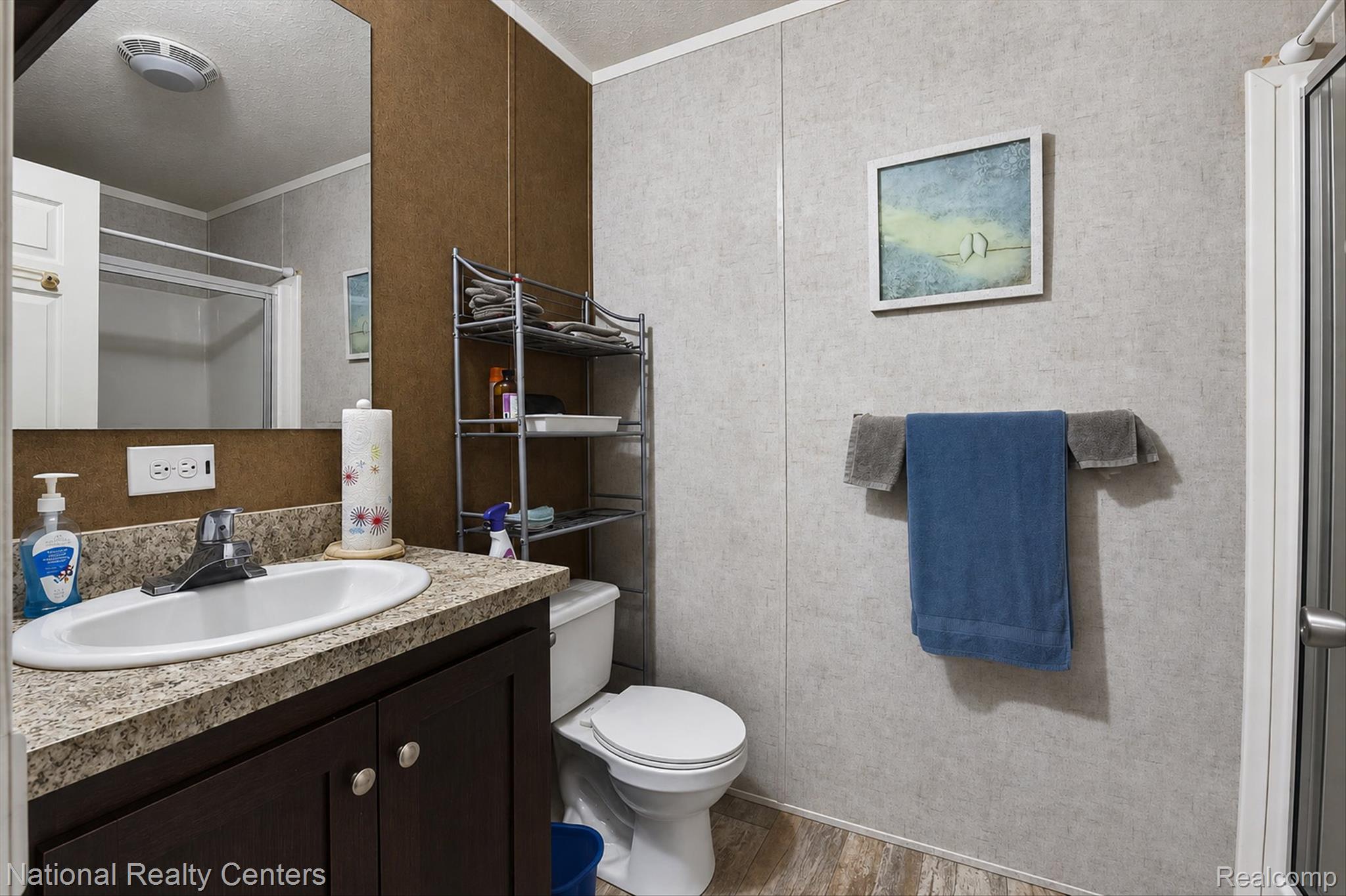 2735 South Wagner Road, Unit 103 Ann Arbor, MI 48103 - Photo 10 of 20 Full bath featuring a stall shower, vanity, light wood-type flooring, and crown molding