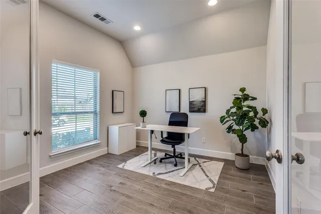 a view of a livingroom with hardwood floor and workspace