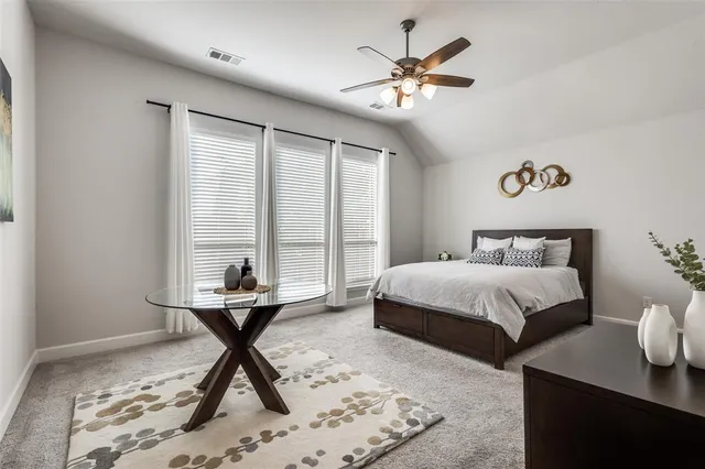 a bedroom with a bed and a table