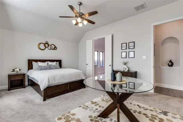 a spacious bedroom with a bed and a table