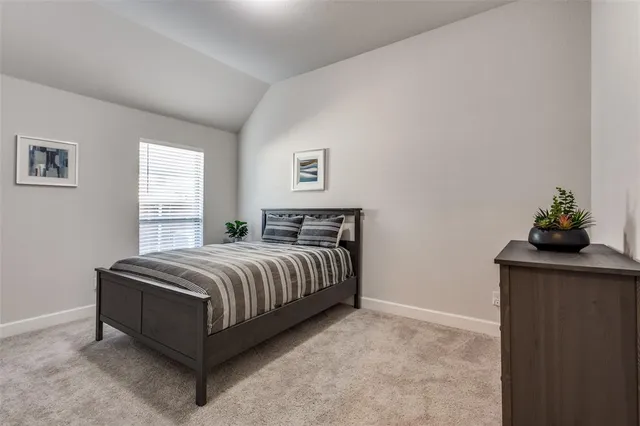a spacious bedroom with a bed and window