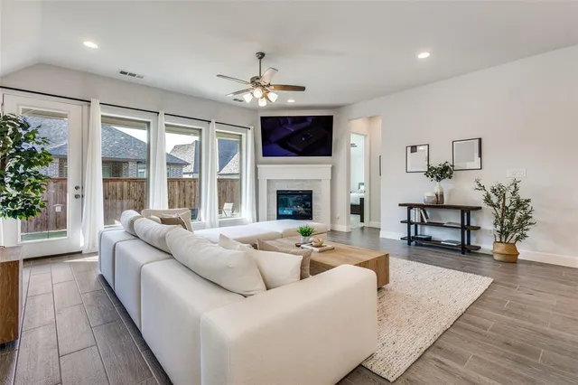 a living room with furniture a fireplace and a flat screen tv
