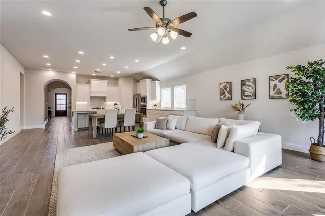 a living room with furniture and a chandelier