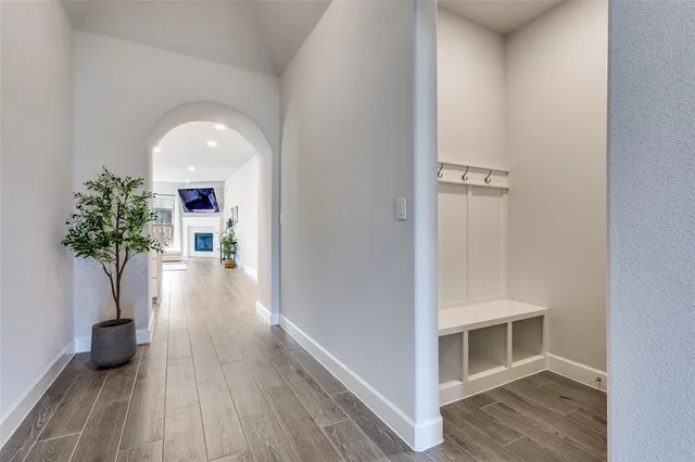 a view of a hallway with wooden floor and staircase