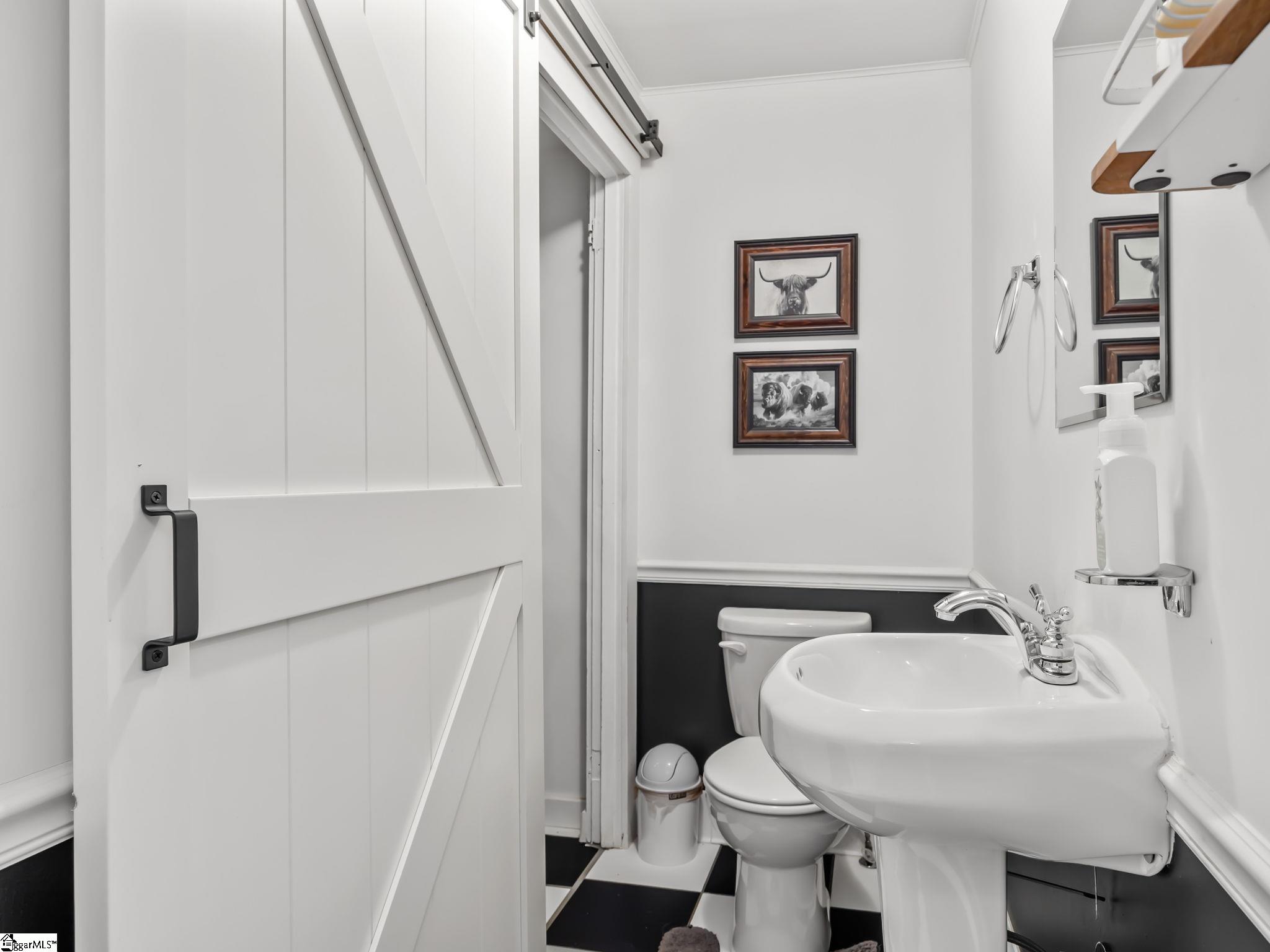 145 Dickson Road Campobello, SC 29322 - Photo 28 of 50 The half bath with sliding barn door leading to the Washer/Dryer and storage area.