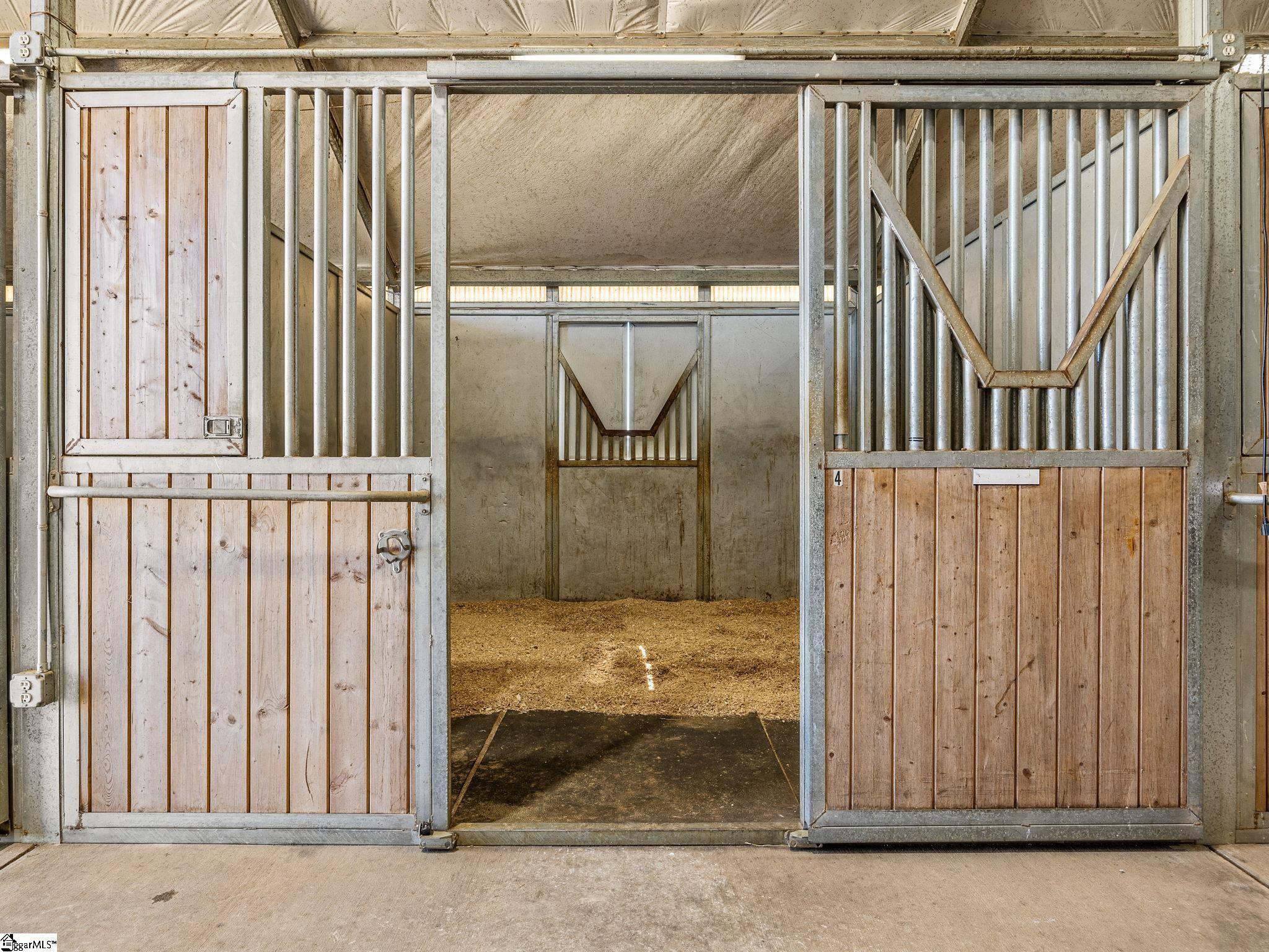 145 Dickson Road Campobello, SC 29322 - Photo 45 of 50 One of 16 stalls in the Main Barn with matted flooring and quality stall fronts that can be adjusted to allow horses to hang their heads into aisle
