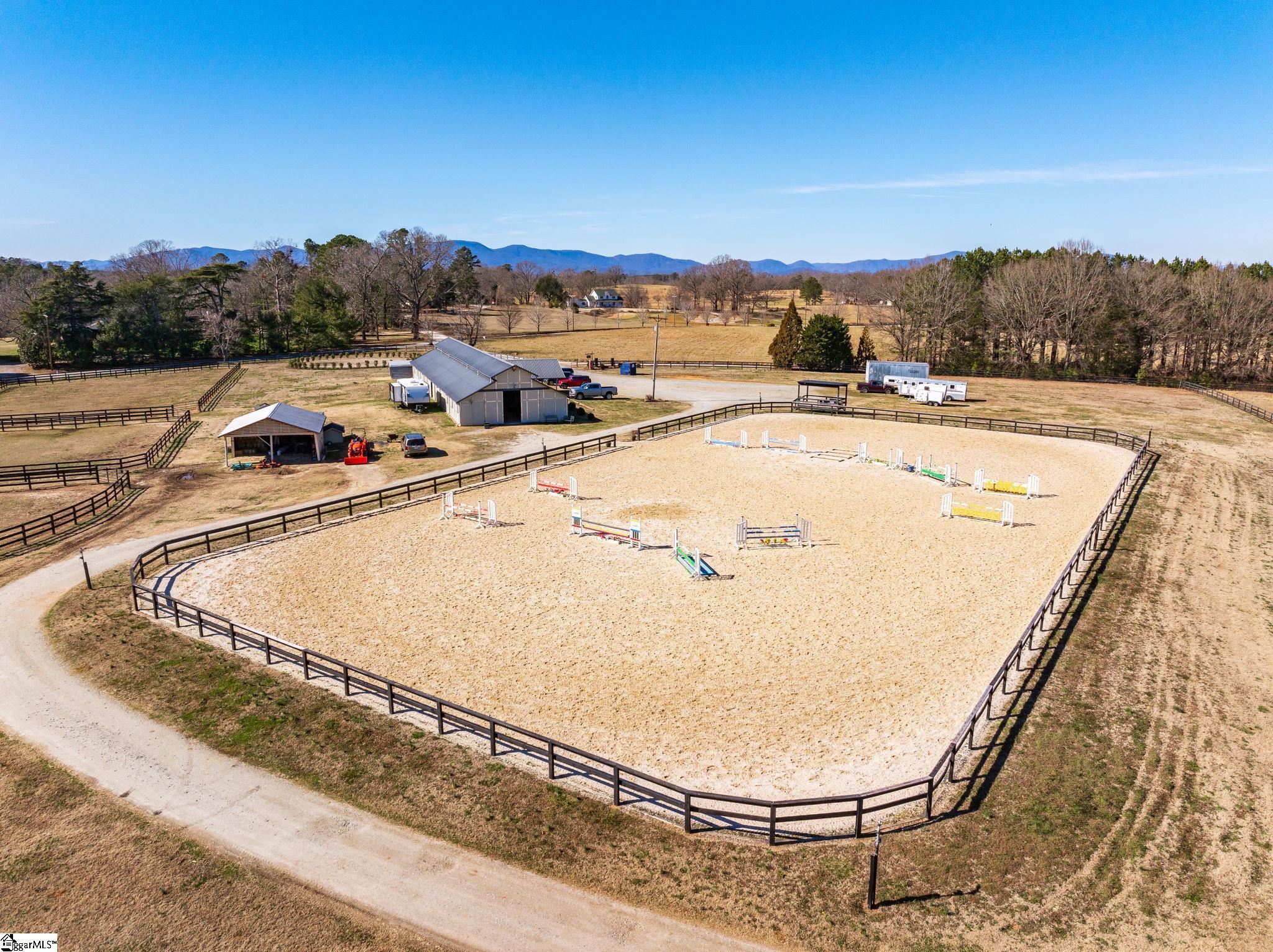 145 Dickson Road Campobello, SC 29322 - Photo 6 of 50 240 ft x 120 ft riding arena with GGT Footing and sprinkler watering system. Raised, covered viewing area for spectators.