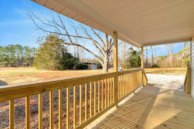 a view of balcony with wooden floor
