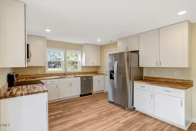 a kitchen with a refrigerator sink and stove top oven