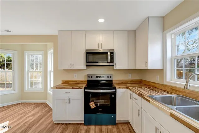 a kitchen with a sink stove and microwave