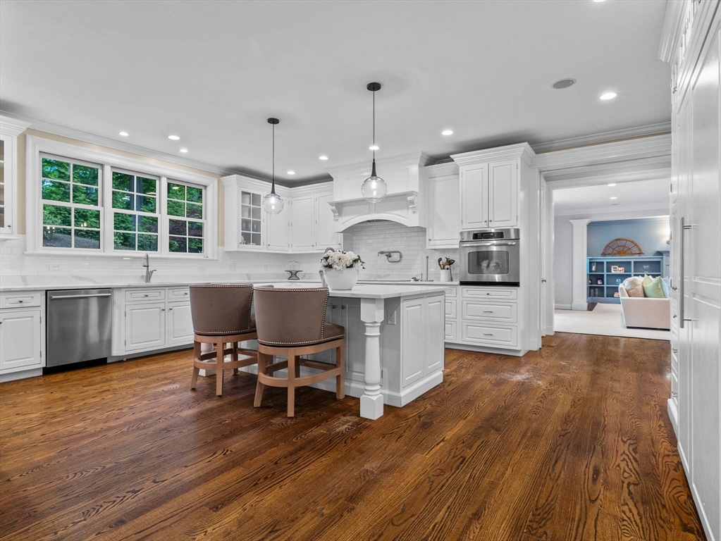 50 Temple Road Wellesley, MA 02482 - Photo 8 of 37 a large kitchen with stainless steel appliances kitchen island granite countertop a large island in the center