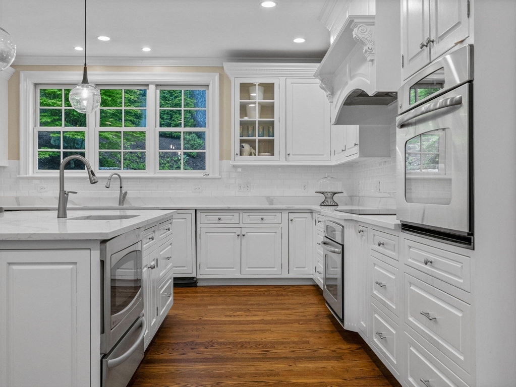 50 Temple Road Wellesley, MA 02482 - Photo 9 of 37 a kitchen with granite countertop white cabinets stainless steel appliances a sink and a large window