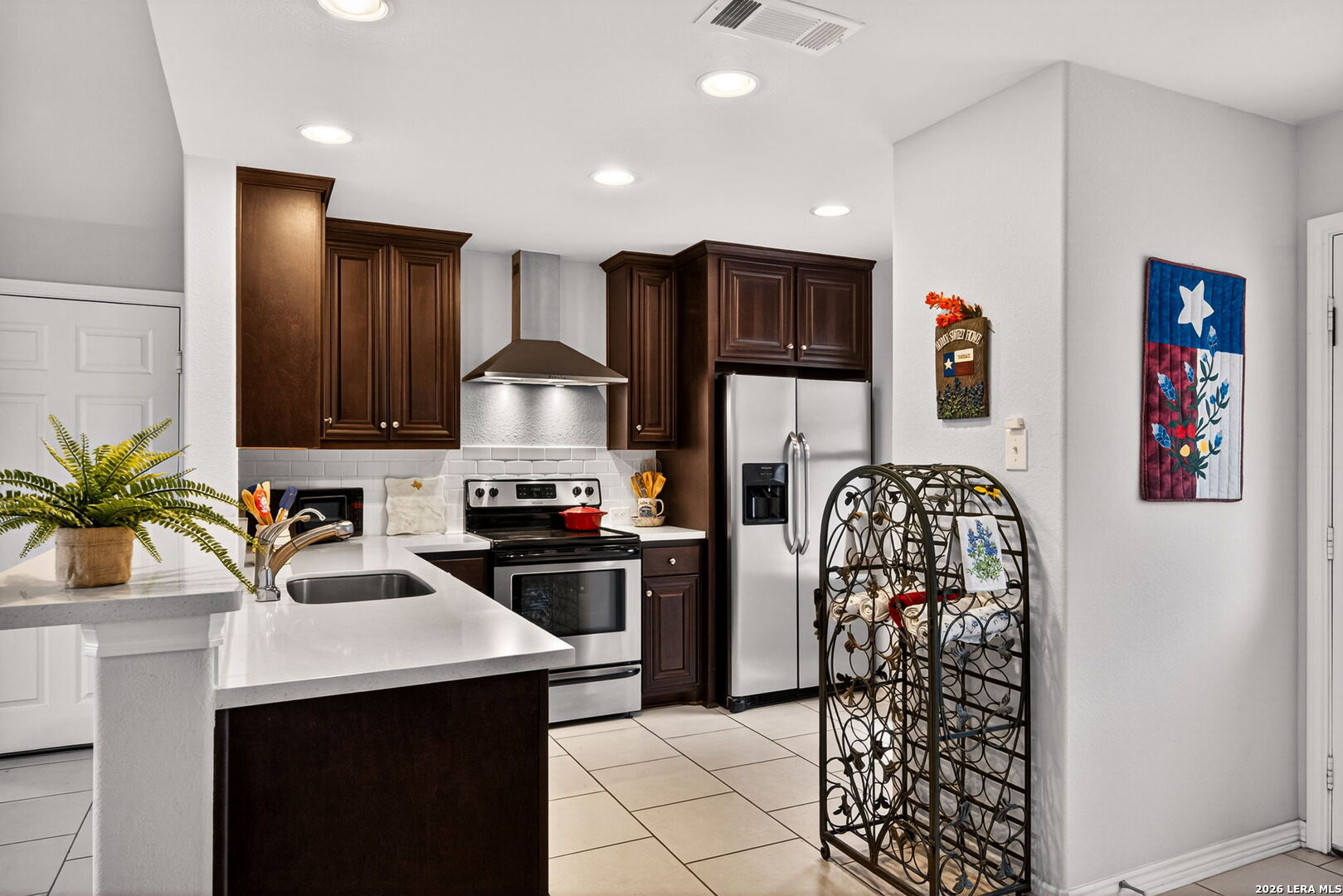 142 Harbour Vw Road Lakehills, TX 78063 - Photo 11 of 38 a kitchen with stainless steel appliances granite countertop a refrigerator and a sink
