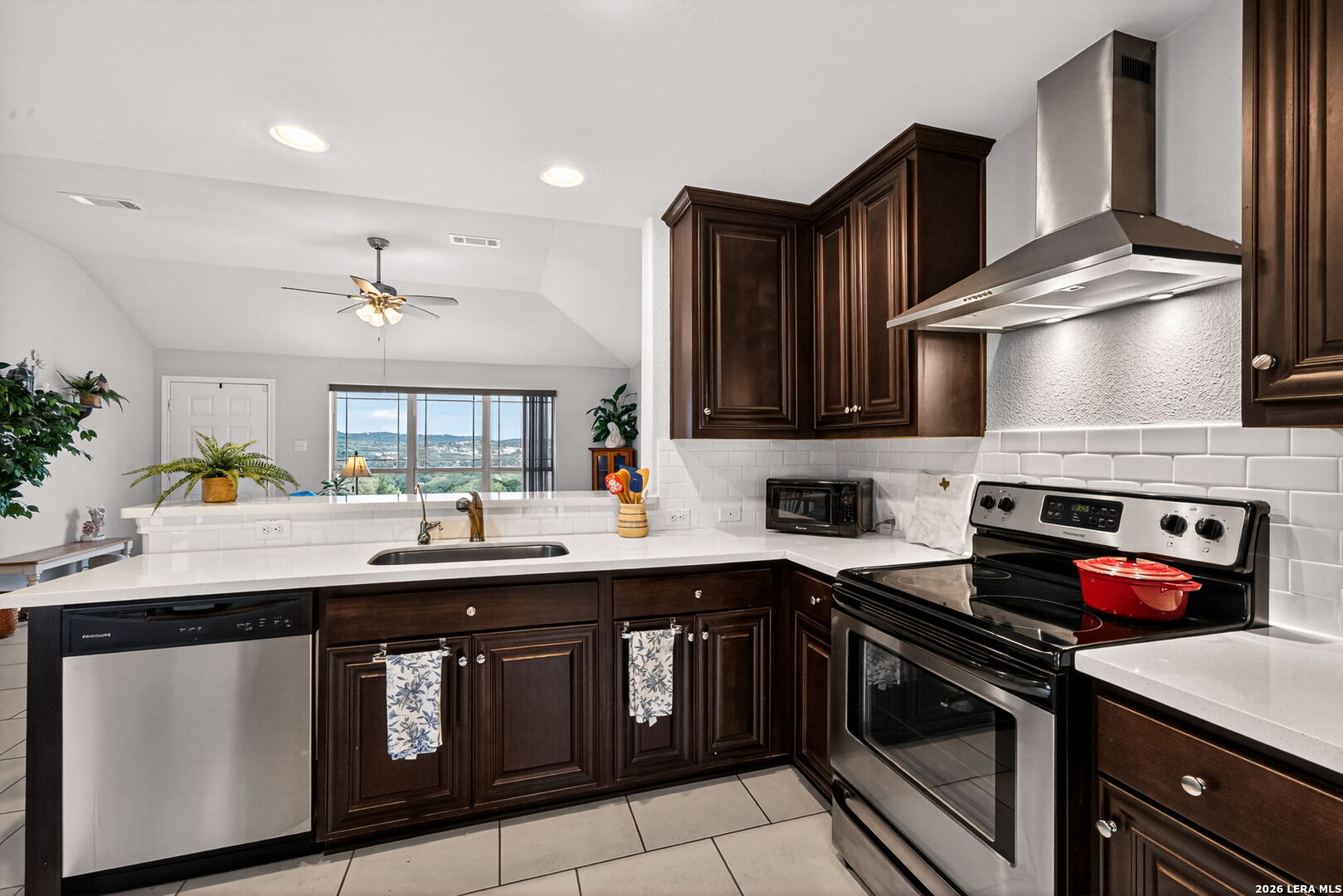 142 Harbour Vw Road Lakehills, TX 78063 - Photo 13 of 38 a kitchen with a sink stove and microwave