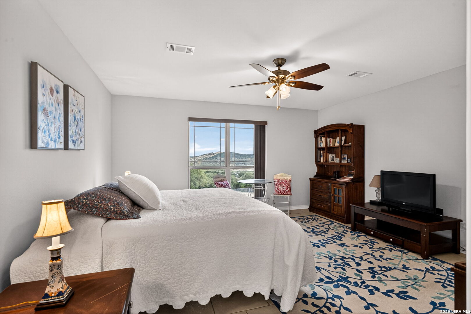 142 Harbour Vw Road Lakehills, TX 78063 - Photo 19 of 38 a bedroom with a bed and a flat screen tv
