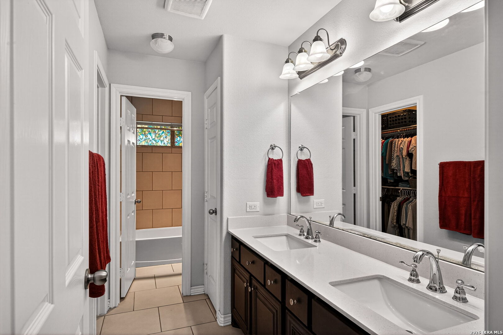 142 Harbour Vw Road Lakehills, TX 78063 - Photo 20 of 38 a bathroom with a double vanity sink and a mirror