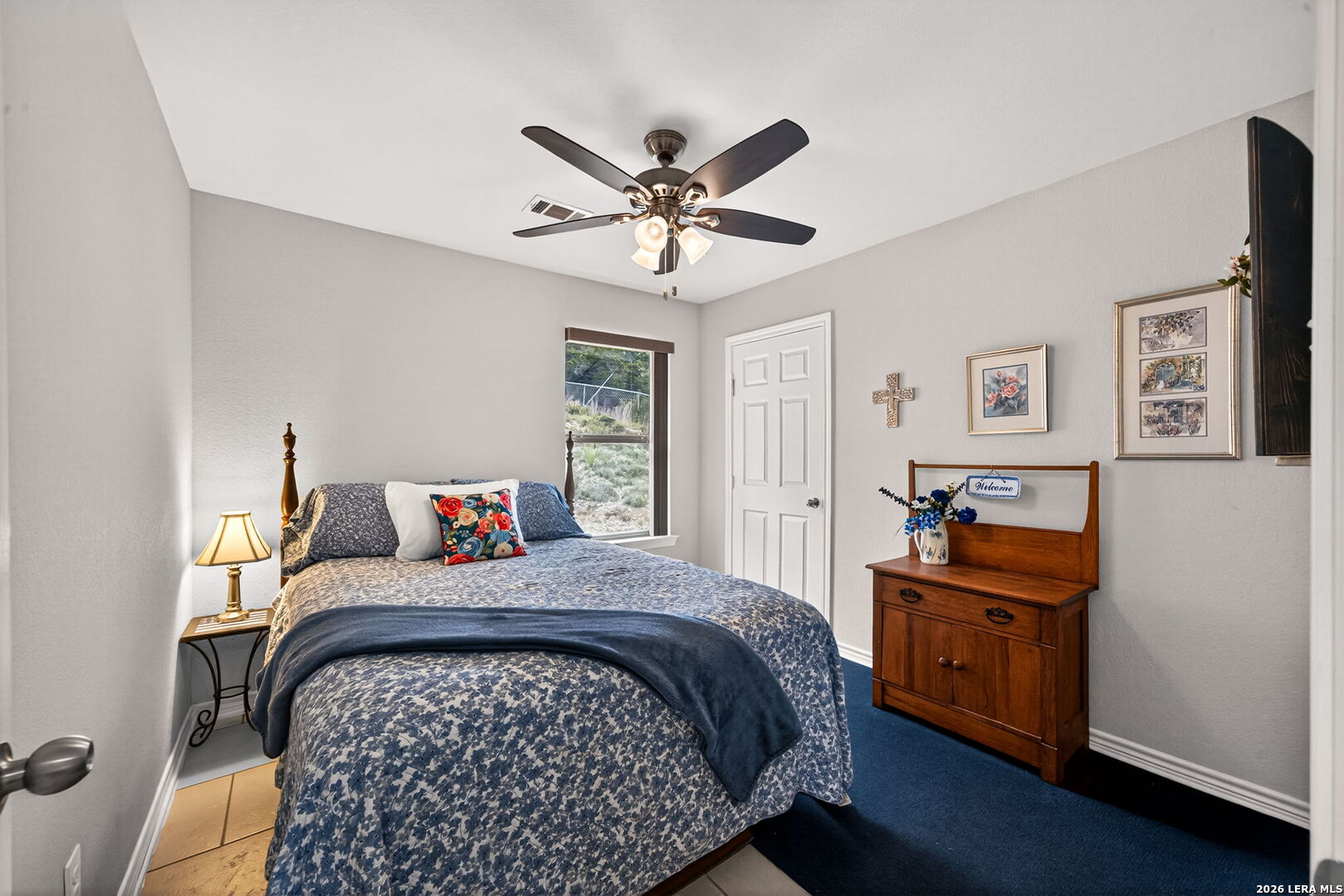 142 Harbour Vw Road Lakehills, TX 78063 - Photo 22 of 38 a bedroom with a bed and a chandelier