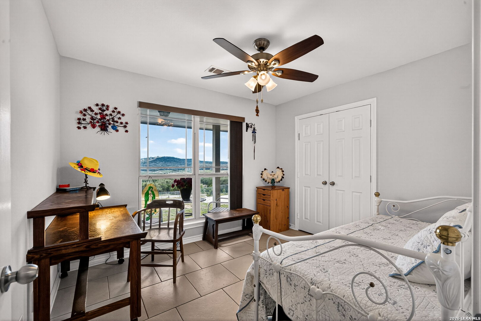 142 Harbour Vw Road Lakehills, TX 78063 - Photo 25 of 38 a bedroom with a bed and a chandelier