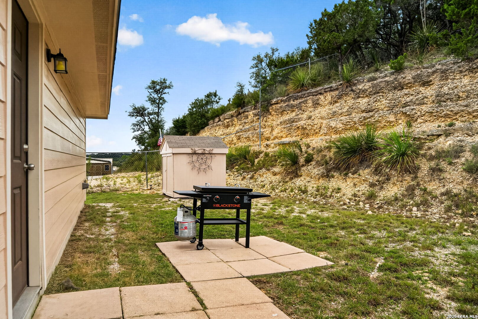 142 Harbour Vw Road Lakehills, TX 78063 - Photo 28 of 38 a view of backyard with a table and chair
