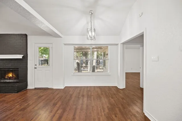 a view of a kitchen and a sink window wooden floor and fire place