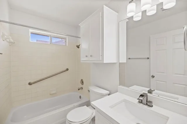 an empty room with wooden floor and window