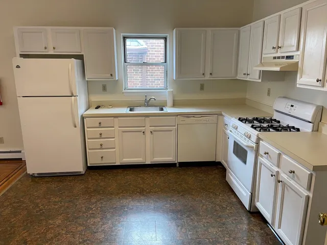 a kitchen with stainless steel appliances a refrigerator sink and cabinets