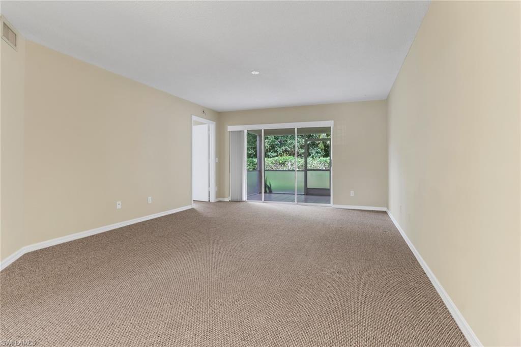 7779 Jewel Lane, Unit 103 Naples, FL 34109 - Photo 11 of 26 an empty room with windows