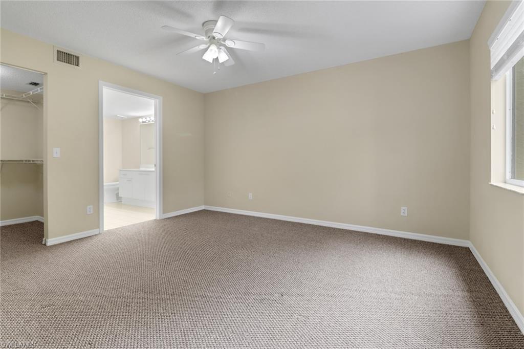 7779 Jewel Lane, Unit 103 Naples, FL 34109 - Photo 15 of 26 an empty room with a window and a fan