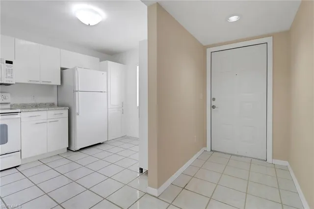 a view of a kitchen with white cabinets