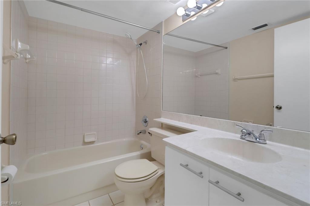 7779 Jewel Lane, Unit 103 Naples, FL 34109 - Photo 21 of 26 a bathroom with a sink toilet and shower