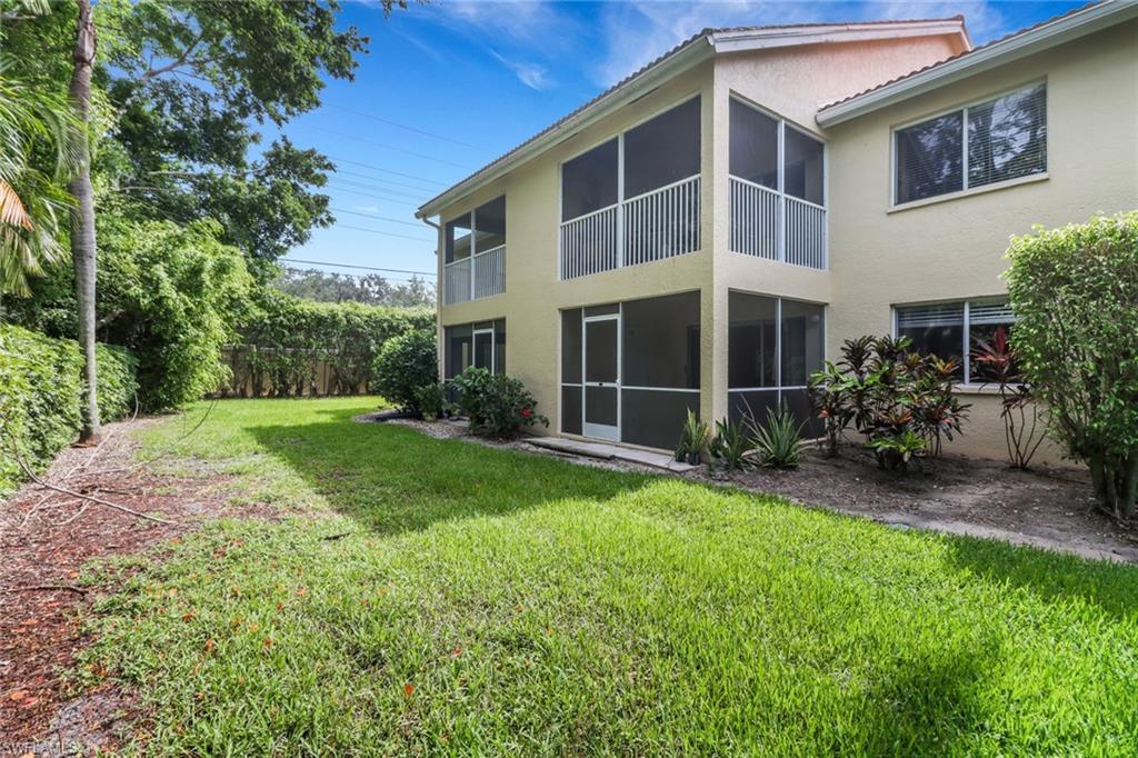 7779 Jewel Lane, Unit 103 Naples, FL 34109 - Photo 24 of 26 a view of backyard with potted plants and large tree