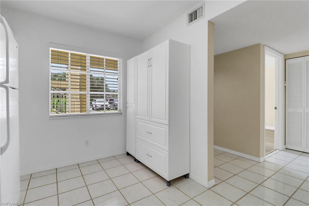 7779 Jewel Lane, Unit 103 Naples, FL 34109 - Photo 6 of 26 a view of an empty room with windows