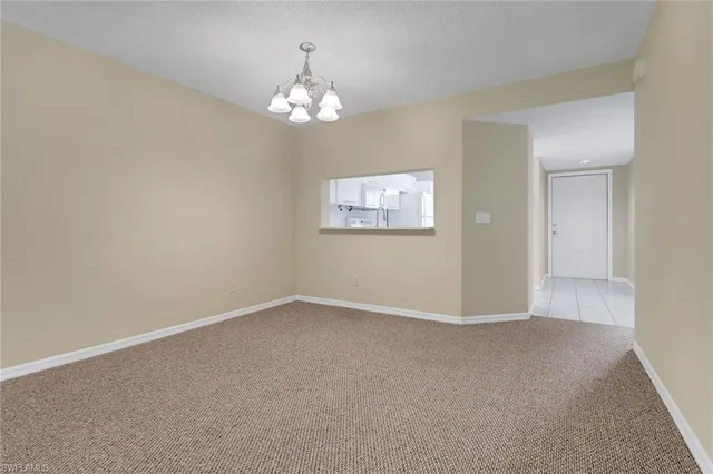 a view of an empty room with a chandelier