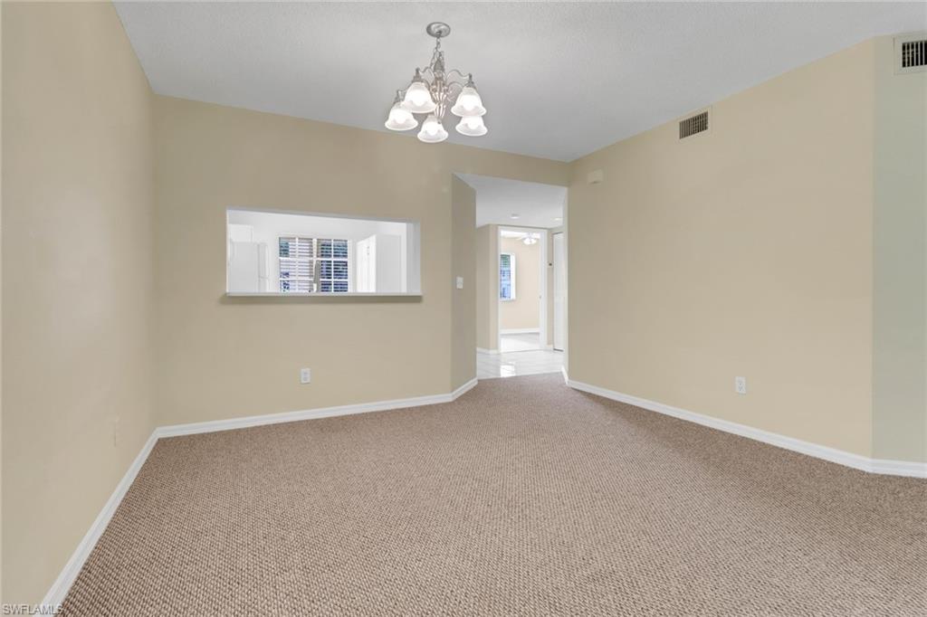 7779 Jewel Lane, Unit 103 Naples, FL 34109 - Photo 10 of 26 a view of an empty room with a window