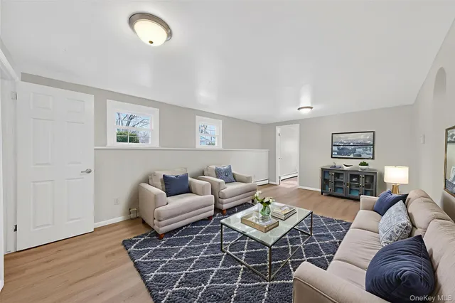 a living room with furniture or couch and a wooden floor