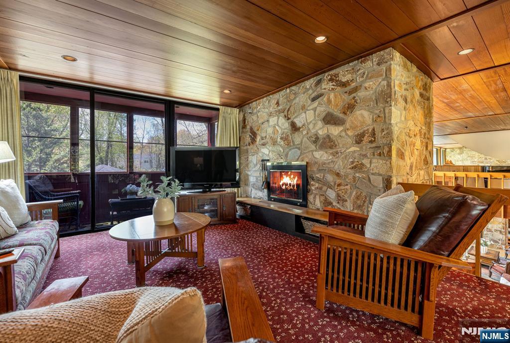 84 Bogerts Mill Road Harrington Park, NJ 07640 - Photo 18 of 47 a living room with furniture a fireplace and a flat screen tv