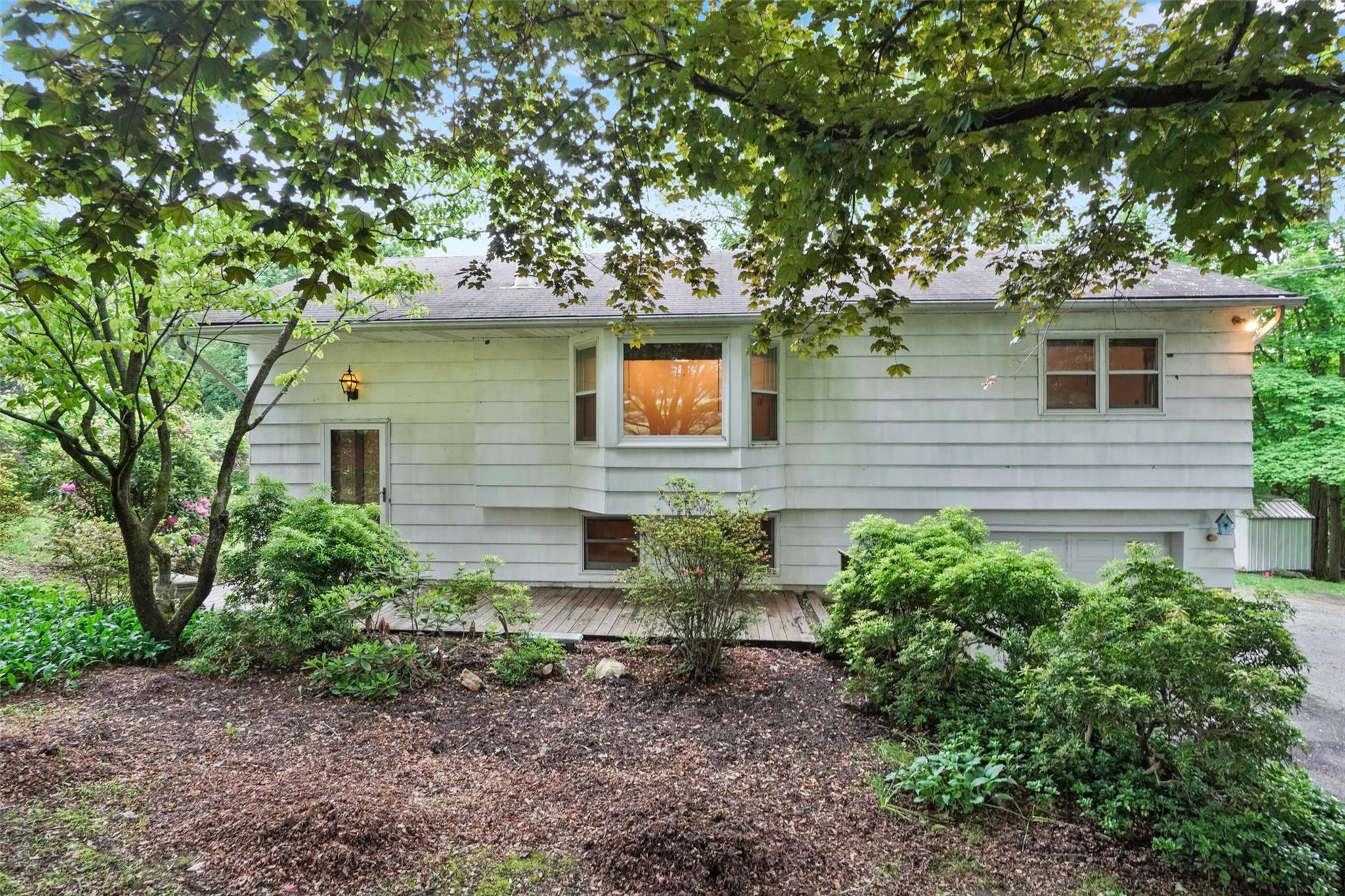 88 Shear Hill Road Mahopac, NY 10541 - Photo 1 of 1 a backyard of a house with plants and large tree