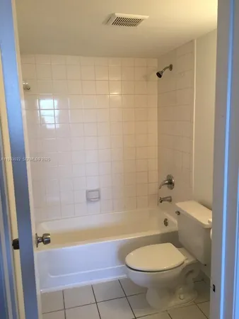 a bathroom with a tub and toilet