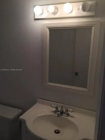 a bathroom with a sink and mirror