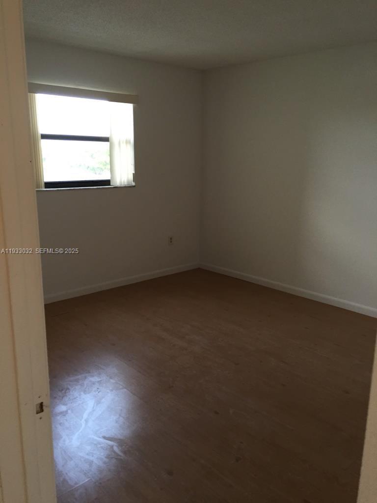 8145 Northwest 7th Street, Unit 406 Miami, FL 33126 - Photo 4 of 9 an empty room with a window