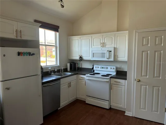 a kitchen with a sink a window and stainless steel appliances