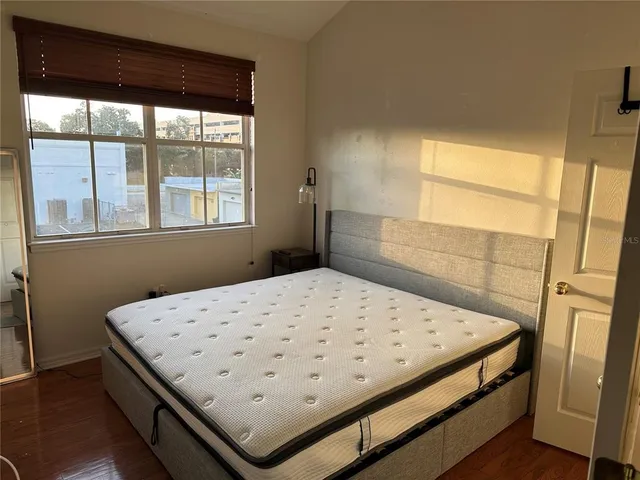 a bedroom with a bed and a window