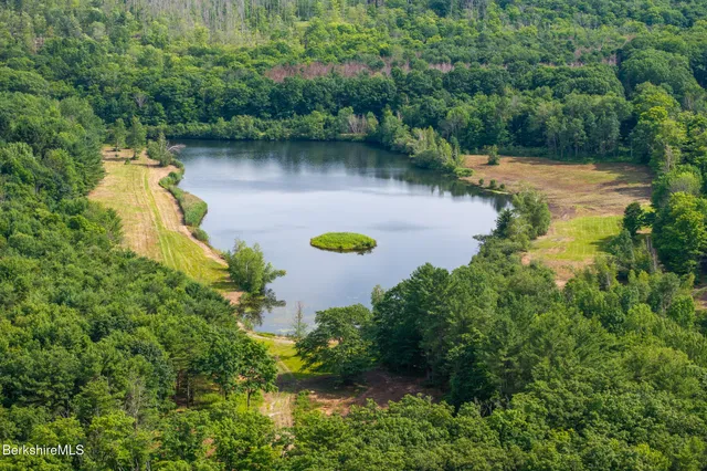 an aerial view of a house with a yard basket ball court and outdoor seating