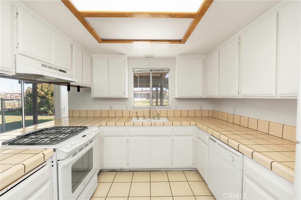 11135 Truchas Road Apple Valley, CA 92308 - Photo 11 of 35 a kitchen with a sink stove and cabinets