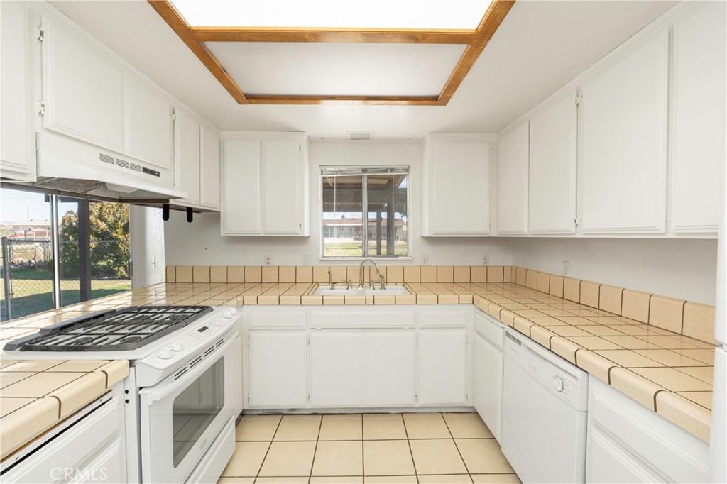 11135 Truchas Road Apple Valley, CA 92308 - Photo 12 of 35 a kitchen with a sink stove and cabinets