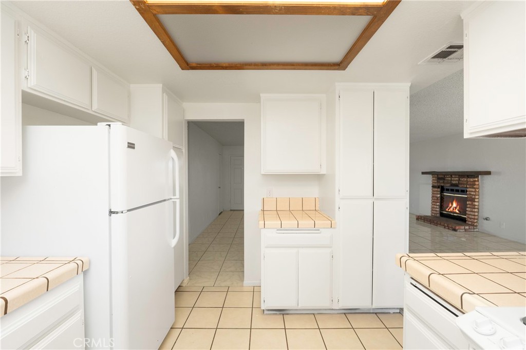 11135 Truchas Road Apple Valley, CA 92308 - Photo 14 of 35 a white refrigerator freezer and a stove sitting inside of a kitchen