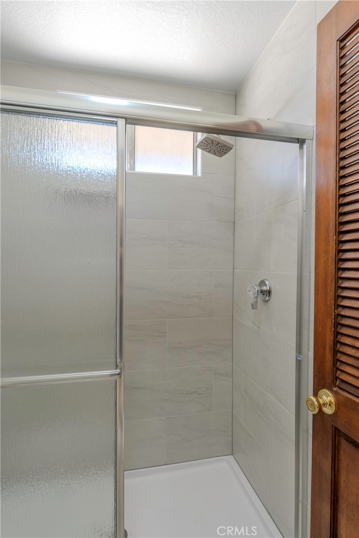 11135 Truchas Road Apple Valley, CA 92308 - Photo 22 of 35 a bathroom with a glass shower door
