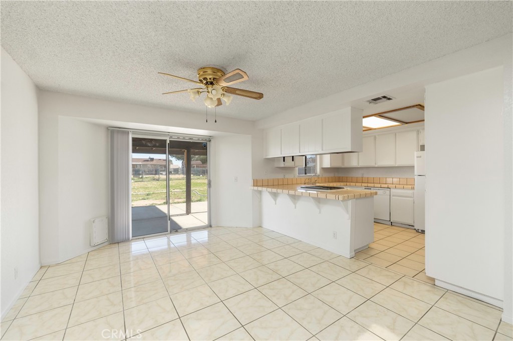 11135 Truchas Road Apple Valley, CA 92308 - Photo 8 of 35 a large white kitchen with a white countertops a sink and a counter top space