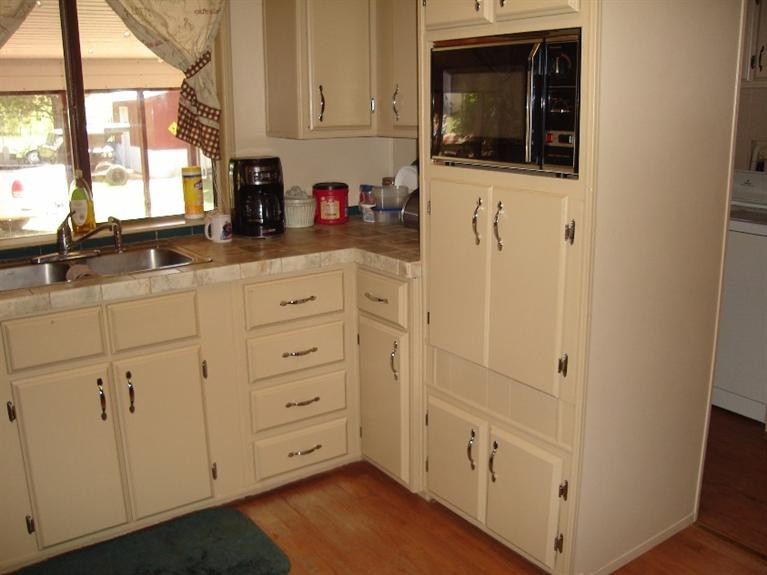 1901 111th Street Lubbock, TX 79423 - Photo 7 of 10 a kitchen with white cabinets and white appliances