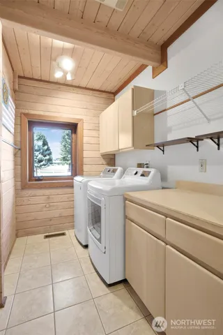 a view of a house with table and chairs in patio
